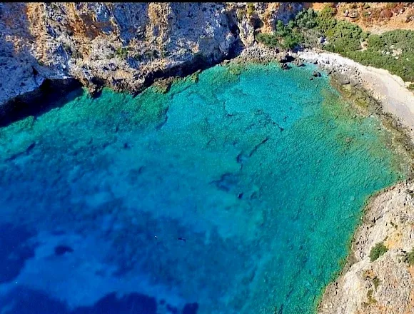 Coastal views of Mênies beach and Hironisia Bay while cruising through Choironisia Bay, Crete.